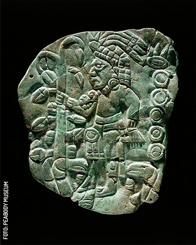 Cenote Chichen Itza Tableta piedra verde con una figura usando un árbol de cacao como cetro, reconstituida y perforada 13. 7 cm x 11.3 cm by Peabody Museum